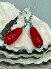 Load image into Gallery viewer, This eye-catching piece set of earrings consists of large fire engine red and tiny teal glass beads for a vibrant and bold look.  Measurements: 1 1/2” in length 
