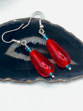 Load image into Gallery viewer, This eye-catching piece set of earrings consists of large fire engine red and tiny teal glass beads for a vibrant and bold look.  Measurements: 1 1/2” in length  
