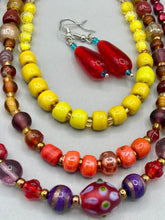 Load image into Gallery viewer, This eye-catching piece set of earrings consists of large fire engine red and tiny teal glass beads for a vibrant and bold look.  Measurements: 1 1/2” in length 
