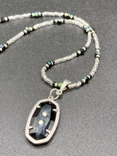 Load image into Gallery viewer, This dainty necklace is full of black and silver shimmery glass beads. A length black oval shaped glass bead hangs low to add length to this necklace.  It&#39;s the perfect necklace to add a little elegance to any outfit. Will go with any outfit, dress it up or down, this necklace will complete any look. This beauty is a must-have, add it to your jewelry collection.  Measurements: Necklace is 15 1/2” adjustable up to 18&quot;- pendant is 1 1/2” Height

