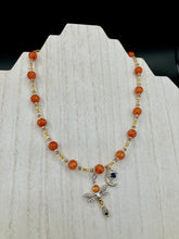 Load image into Gallery viewer, This bright orange, adjustable, choker-style necklace is adorned with beaded glass and a striking crescent moon charm and dragonfly pendant. Accessorize with matching dragonfly earrings for an eye-catching, complementary look that captures the warmth of summer. Perfect for any outfit, its vibrant colors will make a statement and complete any look.  Measurements: Necklace is 16 1/2”adjustable up to 19&quot; 
