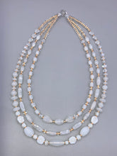 Load image into Gallery viewer, This necklace is the perfect finishing touch to any outfit. Featuring three strands of white and gold glass beads for a classic and elegant look. The small clear and gold glass beads add a touch of sophistication. Adjustable for a comfortable fit.  Measurements:   Necklace is 17” in length, can be adjusted up to 19 1/2" 
