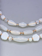 Load image into Gallery viewer, This necklace is the perfect finishing touch to any outfit. Featuring three strands of white and gold glass beads for a classic and elegant look. The small clear and gold glass beads add a touch of sophistication. Adjustable for a comfortable fit.  Measurements:   Necklace is 17” in length, can be adjusted up to 19 1/2" 
