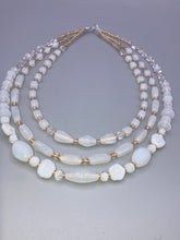 Load image into Gallery viewer, This necklace is the perfect finishing touch to any outfit. Featuring three strands of white and gold glass beads for a classic and elegant look. The small clear and gold glass beads add a touch of sophistication. Adjustable for a comfortable fit.  Measurements:   Necklace is 17” in length, can be adjusted up to 19 1/2" 
