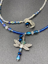 Load image into Gallery viewer, Soft Blue and Silver Adjustable Choker Style Glass Beaded Necklace With A Silver Dragonfly Pendant. Whimsical smiling crescent moon dangling charm comes matching earrings. Dainty elegant summer necklace has the perfect witchy, whimsical, magical, starry night look, it will complete any look.  Measurements: Necklace is 15” adjustable up to 18&quot; in length - pendant is nickel free and 1 1/2” Height
