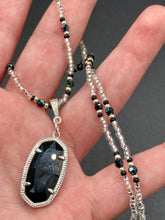 Load image into Gallery viewer, This dainty necklace is full of black and silver shimmery glass beads. A length black oval shaped glass bead hangs low to add length to this necklace.  It&#39;s the perfect necklace to add a little elegance to any outfit. Will go with any outfit, dress it up or down, this necklace will complete any look. This beauty is a must-have, add it to your jewelry collection.  Measurements: Necklace is 15 1/2” adjustable up to 18&quot;- pendant is 1 1/2” Height
