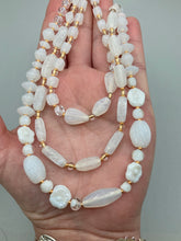 Load image into Gallery viewer, This necklace is the perfect finishing touch to any outfit. Featuring three strands of white and gold glass beads for a classic and elegant look. The small clear and gold glass beads add a touch of sophistication. Adjustable for a comfortable fit.  Measurements:   Necklace is 17” in length, can be adjusted up to 19 1/2" 
