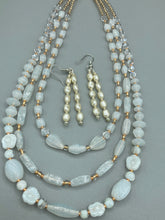 Load image into Gallery viewer, Two long strands of simulated white baroque pearls and silver glass beads come together to create this exquisite accessory.  Measurements: 2” in length 
