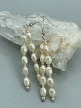 Load image into Gallery viewer, Two long strands of simulated white baroque pearls and silver glass beads come together to create this exquisite accessory.  Measurements: 2” in length 

