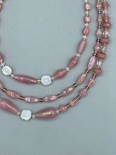 Load image into Gallery viewer, This three-strand beaded necklace is crafted with iridescent dusty rose glass, along with white, gold, pink, and iridescent purple beads for an eclectic mix of colors, tones, and textures. Perfect for any occasion, this gorgeous statement piece will add the finishing touch to your look.   Measurements:   Necklace is 17” in length, can be adjusted up to 19&quot; 
