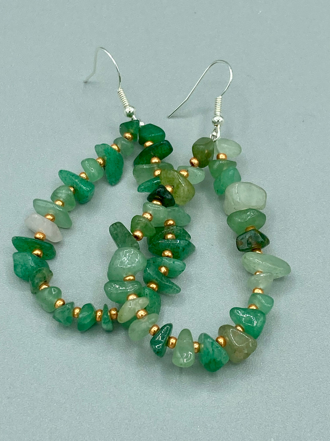 Elegant hoop earrings featuring natural green aventurine stone chips and gold-tinged glass beads. Measurements: 2