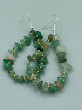 Load image into Gallery viewer, Elegant hoop earrings featuring natural green aventurine stone chips and gold-tinged glass beads.  Measurements: 2&quot; length and 1 1/2” in width  
