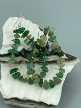 Load image into Gallery viewer, Elegant hoop earrings featuring natural green aventurine stone chips and gold-tinged glass beads.  Measurements: 2&quot; length and 1 1/2” in width  
