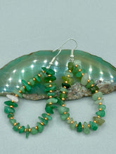 Load image into Gallery viewer, Elegant hoop earrings featuring natural green aventurine stone chips and gold-tinged glass beads. Measurements: 2&quot; length and 1 1/2” in width  

