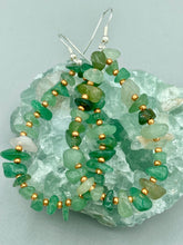 Load image into Gallery viewer, Elegant hoop earrings featuring natural green aventurine stone chips and gold-tinged glass beads. Measurements: 2&quot; length and 1 1/2” in width  
