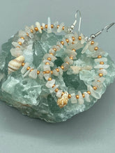 Load image into Gallery viewer, Natural white moon stone chip with white and gold glass beaded hoop earrings with super tiny natural conch shells.  Nature lovers, beach vibes, summer earring will compliment any look.   Measurements: 2&quot; length
