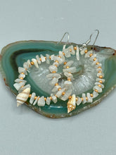 Load image into Gallery viewer, These beautiful white moon stone chip and gold glass beaded hoop earrings feature natural conch shells, perfect for a touch of nature-inspired masterful craftsmanship. A must-have accessory for those with a love of the outdoors, beach, and summertime.   Measurements: 1 3/4" length
