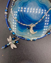 Load image into Gallery viewer, Soft Blue and Silver Adjustable Choker Style Glass Beaded Necklace With A Silver Dragonfly Pendant. Whimsical smiling crescent moon dangling charm comes matching earrings. Dainty elegant summer necklace has the perfect witchy, whimsical, magical, starry night look, it will complete any look.  Measurements: Necklace is 15” adjustable up to 18&quot; in length - pendant is nickel free and 1 1/2” Height
