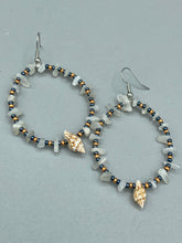 Load image into Gallery viewer, Dainty conch shells and natural white moon stone chips, these dark silver and gold glass beaded hoop earrings are the perfect accessory for any nature-loving, beach-themed outfit. Their versatility allows them to easily complement any outfit.  Measurements: 2 1/4&quot; length
