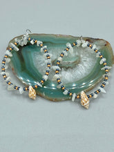 Load image into Gallery viewer, Dainty conch shells and natural white moon stone chips, these dark silver and gold glass beaded hoop earrings are the perfect accessory for any nature-loving, beach-themed outfit. Their versatility allows them to easily complement any outfit.  Measurements: 2 1/4&quot; length
