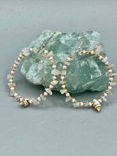 Load image into Gallery viewer, Delicate white moon stone chip and glass beaded hoop earrings featuring chic gold accents and tiny conch shells. Perfect for nature lovers, these boho-inspired summer earrings will add a subtle sophistication to any outfit. Measurements: 2" length
