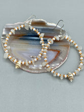 Load image into Gallery viewer, Delicate white moon stone chip and glass beaded hoop earrings featuring chic gold accents and tiny conch shells. Perfect for nature lovers, these boho-inspired summer earrings will add a subtle sophistication to any outfit. Measurements: 2" length
