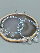 Load image into Gallery viewer, These Pressed Glass Leaf Beaded Hoop Earrings are perfect for a shabby chic, bohemian, or hippie vibe. The iridescent glass beads give off a soft and glamorous sparkle, while the clear glass charms have a shimmer finish with hints of gold, purple, blue and pink. They are the perfect nature-inspired accessory. Measurements: 2&quot; length
