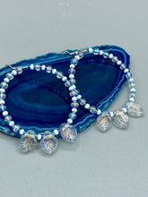 Load image into Gallery viewer, These Pressed Glass Leaf Beaded Hoop Earrings are perfect for a shabby chic, bohemian, or hippie vibe. The iridescent glass beads give off a soft and glamorous sparkle, while the clear glass charms have a shimmer finish with hints of gold, purple, blue and pink. They are the perfect nature-inspired accessory. Measurements: 2&quot; length
