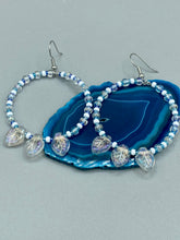 Load image into Gallery viewer, These Pressed Glass Leaf Beaded Hoop Earrings are perfect for a shabby chic, bohemian, or hippie vibe. The iridescent glass beads give off a soft and glamorous sparkle, while the clear glass charms have a shimmer finish with hints of gold, purple, blue and pink. They are the perfect nature-inspired accessory. Measurements: 2&quot; length
