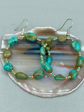 Load image into Gallery viewer, Our Blue-Green Magnesite Stone Beaded Hoop Earrings provide a nature-inspired look that is perfect for any boho-chic style. These earrings feature natural magnesite stone beads with small beads of turquoise and gold glass for subtle accent. Show off your bohemian look with these eye-catching hoops. Measurements: 2&quot; length 
