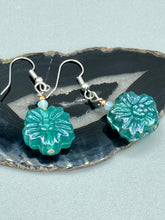 Load image into Gallery viewer, Upgrade your style with these sophisticated blue-green floral pressed glass earrings. Their iridescent glimmer finish adds a glamorous touch for any occasion. Crafted from lightweight glass, each design is both eye-catching and comfortable to wear. Measurements: 1 1/4&quot; length
