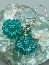Load image into Gallery viewer, Upgrade your style with these sophisticated blue-green floral pressed glass earrings. Their iridescent glimmer finish adds a glamorous touch for any occasion. Crafted from lightweight glass, each design is both eye-catching and comfortable to wear. Measurements: 1 1/4&quot; length
