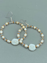 Load image into Gallery viewer, These white floral glass beaded hoop earrings bring a bohemian, shabby-chic, and nature-inspired vibe to any look. Crafted with small iridescent, gold, and white glass beads, they are the perfect accessory for any fashionista who loves beach vibes, summer elements, and chic boho styles. Measurements: 2 1/4" length
