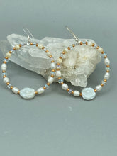 Load image into Gallery viewer, These white floral glass beaded hoop earrings bring a bohemian, shabby-chic, and nature-inspired vibe to any look. Crafted with small iridescent, gold, and white glass beads, they are the perfect accessory for any fashionista who loves beach vibes, summer elements, and chic boho styles. Measurements: 2 1/4" length
