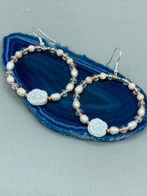 Load image into Gallery viewer, These white floral glass beaded hoop earrings bring a bohemian, shabby-chic, and nature-inspired vibe to any look. Crafted with small iridescent, gold, and white glass beads, they are the perfect accessory for any fashionista who loves beach vibes, summer elements, and chic boho styles. Measurements: 2 1/4" length
