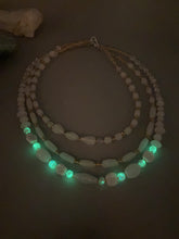 Load image into Gallery viewer, This necklace is the perfect finishing touch to any outfit. Featuring three strands of white and gold glass beads for a classic and elegant look. The small clear and gold glass beads add a touch of sophistication. Adjustable for a comfortable fit.  Measurements:   Necklace is 17” in length, can be adjusted up to 19 1/2" 
