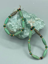 Load image into Gallery viewer, These stylish fish hook style earrings feature intricate beadwork crafted with forest green magnesite and ruby zoisite stones. Measurements: 2 3/4&quot; length
