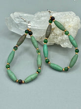 Load image into Gallery viewer, These stylish fish hook style earrings feature intricate beadwork crafted with forest green magnesite and ruby zoisite stones. Measurements: 2 3/4&quot; length
