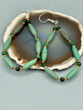 Load image into Gallery viewer, These stylish fish hook style earrings feature intricate beadwork crafted with forest green magnesite and ruby zoisite stones. Measurements: 2 3/4&quot; lengthThese stylish fish hook style earrings feature intricate beadwork crafted with forest green magnesite and ruby zoisite stones. Measurements: 2 3/4&quot; length
