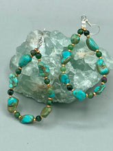Load image into Gallery viewer, These earrings feature blue-green magnesite and ruby zoisite stones set in gold glass beaded hoops. Measurements: 2 1/2&quot; length 
