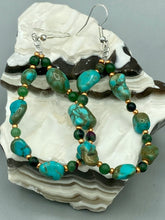 Load image into Gallery viewer, These earrings feature blue-green magnesite and ruby zoisite stones set in gold glass beaded hoops. Measurements: 2 1/2&quot; length 
