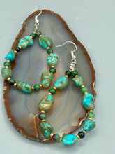 Load image into Gallery viewer, These earrings feature blue-green magnesite and ruby zoisite stones set in gold glass beaded hoops. Measurements: 2 1/2&quot; length 

