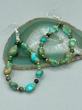 Load image into Gallery viewer, These earrings feature blue-green magnesite and ruby zoisite stones set in gold glass beaded hoops. Measurements: 2 1/2&quot; length 
