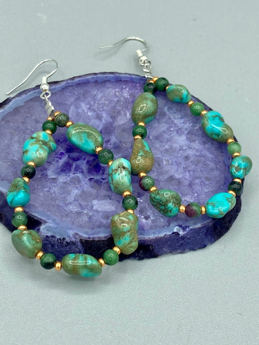 These earrings feature blue-green magnesite and ruby zoisite stones set in gold glass beaded hoops. Measurements: 2 1/2