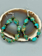 Load image into Gallery viewer, These earrings feature blue-green magnesite and ruby zoisite stones set in gold glass beaded hoops. Measurements: 2 1/2&quot; length 
