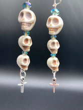 Load image into Gallery viewer, For The Dark Souls Three Howlite Skull Beads Light Blue Iridescent Glass Bead Earrings Dangling Silver Plated Cross Give These Earrings Movement. Chingona, Cabrona, Latina Chicana, Goth, Vampire Goth, Dark Witchy Style. You can dress these up or down, it will definitely give your outfit a unique look.  Measurements: 3 ” in length
