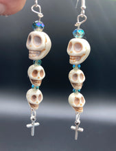 Load image into Gallery viewer, For The Dark Souls Three Howlite Skull Beads Light Blue Iridescent Glass Bead Earrings Dangling Silver Plated Cross Give These Earrings Movement. Chingona, Cabrona, Latina Chicana, Goth, Vampire Goth, Dark Witchy Style. You can dress these up or down, it will definitely give your outfit a unique look.  Measurements: 3 ” in length
