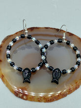 Load image into Gallery viewer, This sophisticated pair of earrings features a black glass fish bead, complemented by small iridescent and dark gray color glass beads, with eye and fin details. Measurements: 2” in length  
