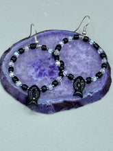 Load image into Gallery viewer, This sophisticated pair of earrings features a black glass fish bead, complemented by small iridescent and dark gray color glass beads, with eye and fin details. Measurements: 2” in length  

