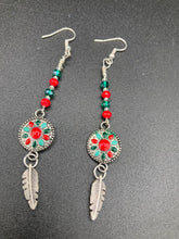 Load image into Gallery viewer, These Southwester Style Silver Feather Light Dainty Beaded Earrings are richly adorned with turquoise, bright red and dark green, and feature silver plated feather charms for a fun, dynamic effect. A perfect match for any Chingona Carbrona, La India Princess, Fierce Goddess Warrior, or Tribal Pattern look.  Measurements: 3” in length
